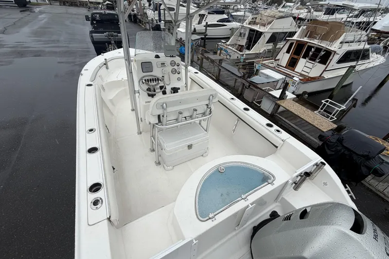 Slide: The Image of 2010 Sea Fox 216 Center Console boat docked, featuring a spacious deck and modern controls. - 13