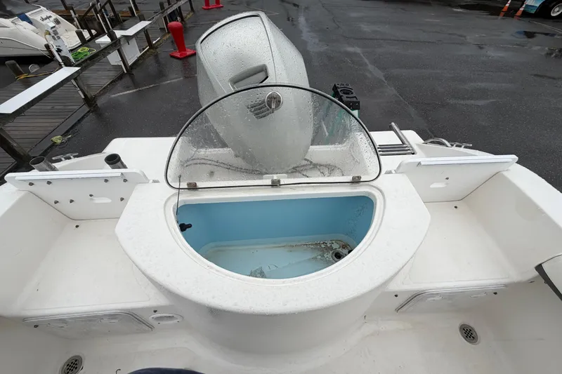 Slide: The Image of 2010 Sea Fox 216 Center Console boat with open livewell and outboard motor. - 16