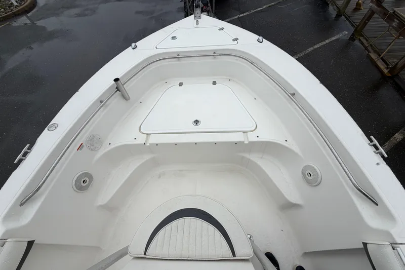 Slide: The Image of 2010 Sea Fox 216 Center Console boat interior, featuring spacious seating and storage compartments. - 23
