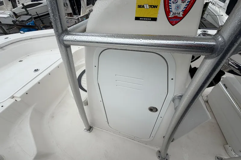 Slide: The Image of 2010 Sea Fox 216 Center Console boat interior with storage compartment and safety stickers. - 27