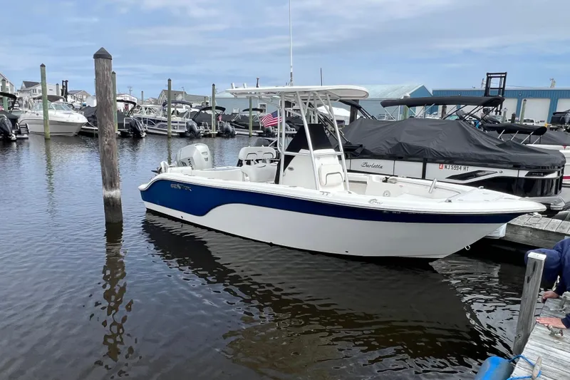 Slide: The Image of 2010 Sea Fox 216 Center Console boat docked in a marina, surrounded by other vessels. - 6
