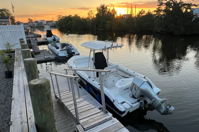 Slide: The Image of 2010 Sea Fox 216 Center Console boat docked at sunset on a tranquil river. - 9