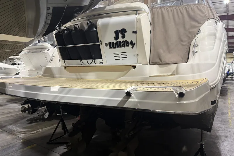 Slide: The Image of 2002 Rinker Fiesta Vee 342 boat in storage, rear view with swim platform. - 1