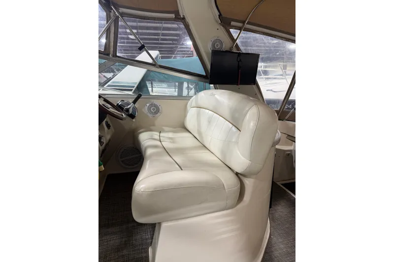Slide: The Image of 2002 Rinker Fiesta Vee 342 helm with white leather seating and steering wheel. - 10