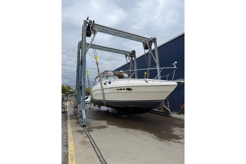 Slide: The Image of 2002 Rinker Fiesta Vee 342 boat on lift, marina background, overcast sky. - 15