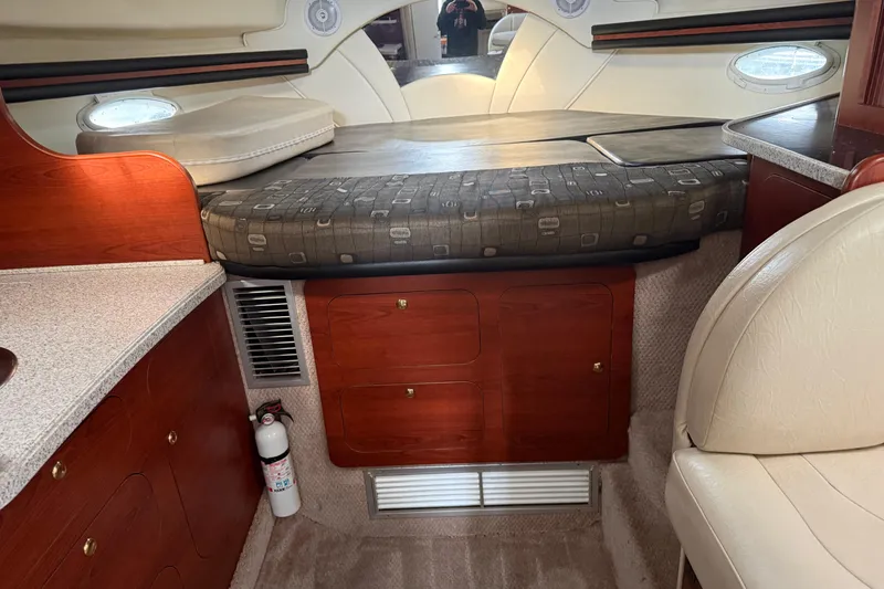 Slide: The Image of Interior cabin of 2002 Rinker Fiesta Vee 342 with bed and wooden cabinetry. - 17