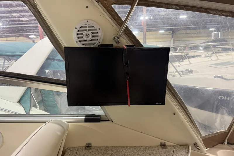 Slide: The Image of Interior of 2002 Rinker Fiesta Vee 342 with mounted Vizio TV and Kenwood speaker. - 2