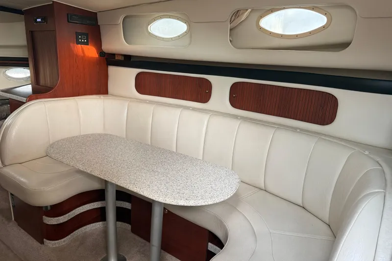 Slide: The Image of 2002 Rinker Fiesta Vee 342 interior with white leather seating and oval windows. - 21