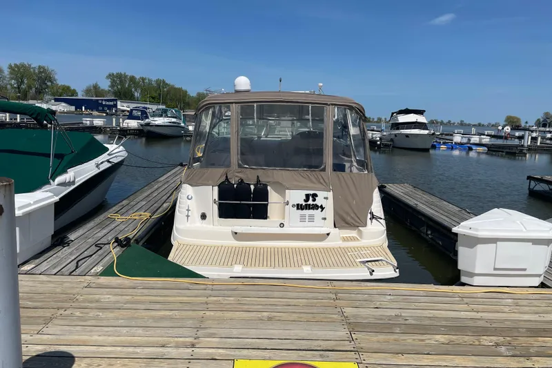 Slide: The Image of 2002 Rinker Fiesta Vee 342 docked at a marina under clear blue skies. - 25