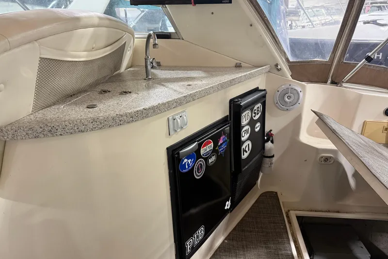 Slide: The Image of 2002 Rinker Fiesta Vee 342 boat interior with kitchenette and mini fridge. - 3