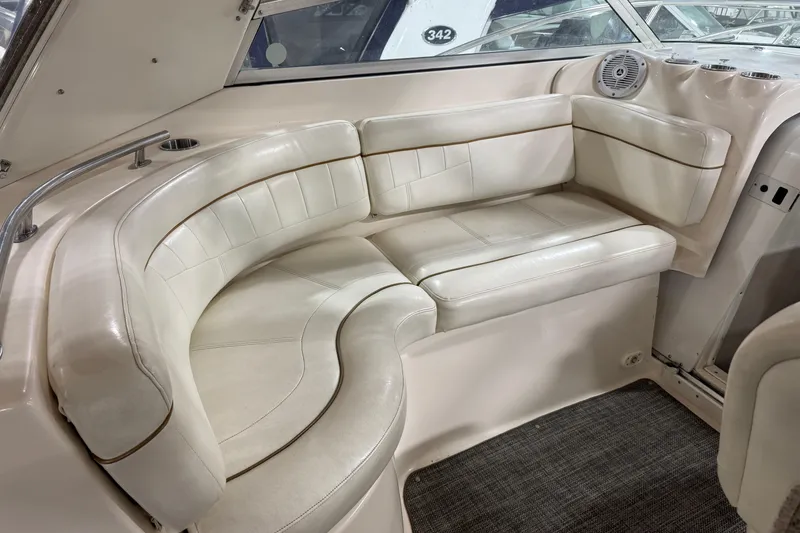 Slide: The Image of 2002 Rinker Fiesta Vee 342 boat interior with white leather seating and carpeted floor. - 8