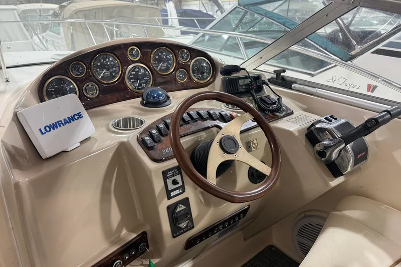Slide: The Image of 2002 Rinker Fiesta Vee 342 helm with gauges, Lowrance device, and steering wheel. - 9
