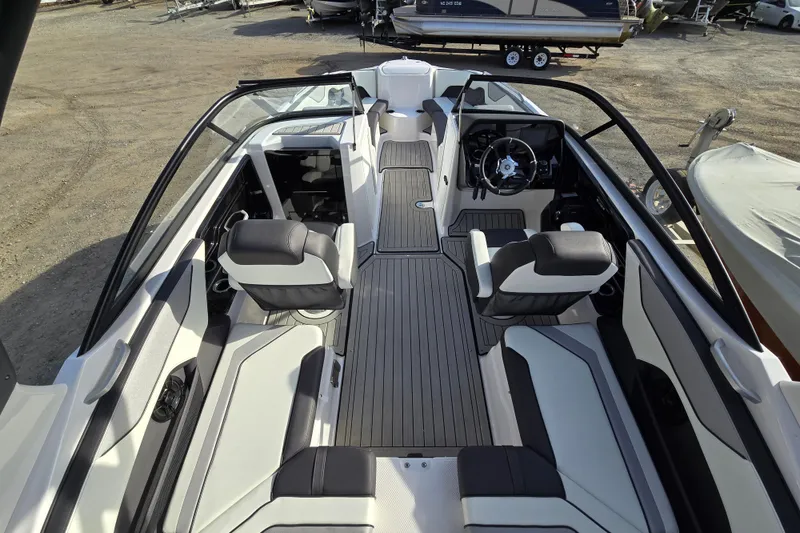 Slide: The Image of 2022 Yamaha Boats 212S interior with sleek seating and modern dashboard design. - 17