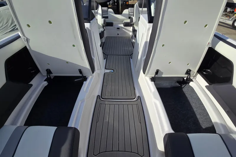 Slide: The Image of 2022 Yamaha Boats 212S interior with open seating and sleek flooring design. - 20