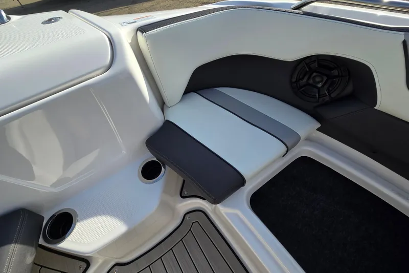 Slide: The Image of Interior seating of 2022 Yamaha Boats 212S with cup holders and speaker. - 22