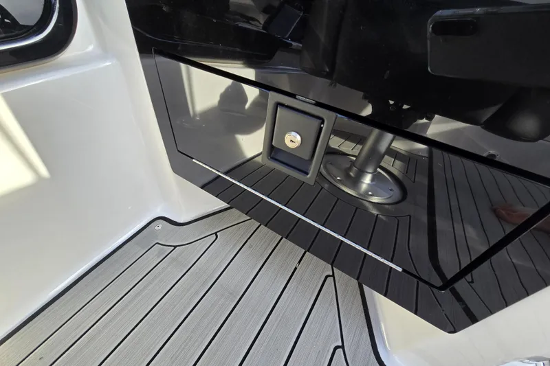 Slide: The Image of Interior view of 2022 Yamaha Boats 212S, featuring sleek black panel and modern flooring. - 28