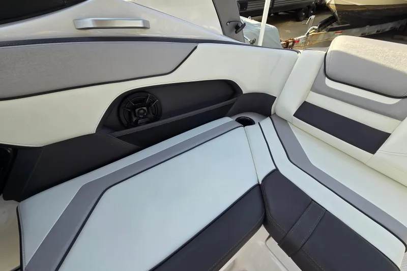 Slide: The Image of 2022 Yamaha Boats 212S interior seating with speaker and cup holder. - 30