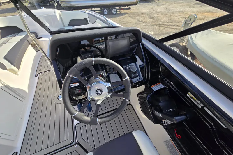 Slide: The Image of 2022 Yamaha Boats 212S cockpit with steering wheel and control panel. - 31