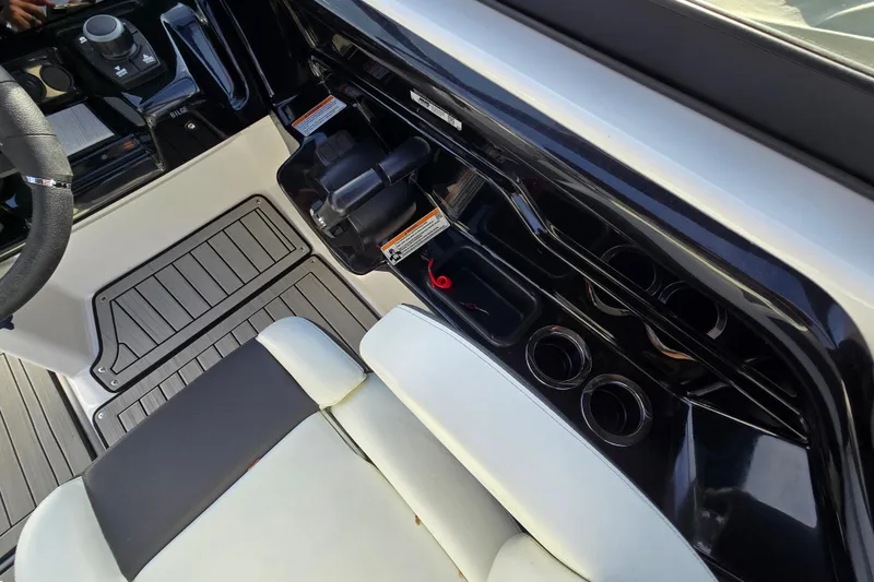 Slide: The Image of Interior view of 2022 Yamaha Boats 212S, showcasing sleek dashboard and seating. - 32