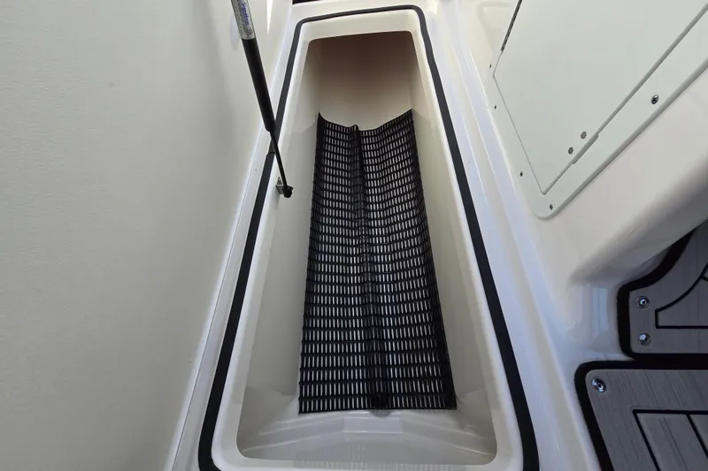 Slide: The Image of Storage compartment in 2022 Yamaha Boats 212S, featuring a black non-slip mat. - 34