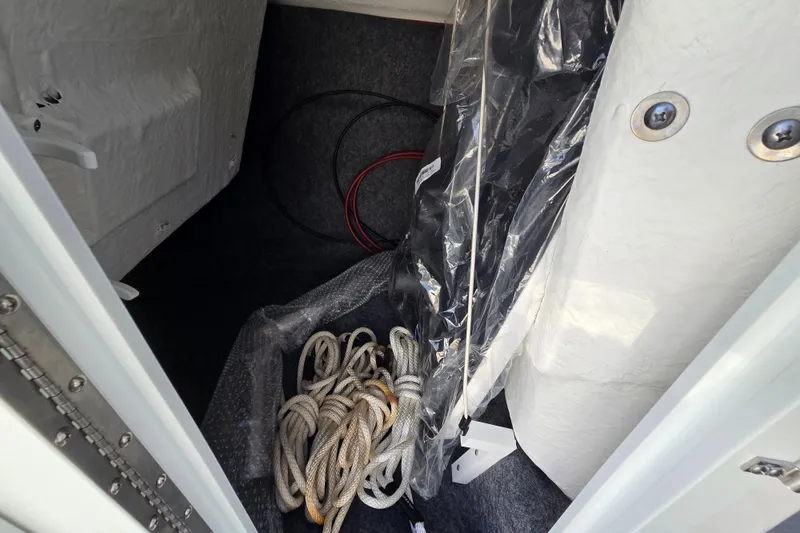 Slide: The Image of Storage compartment of 2022 Yamaha Boats 212S with ropes and cables. - 35