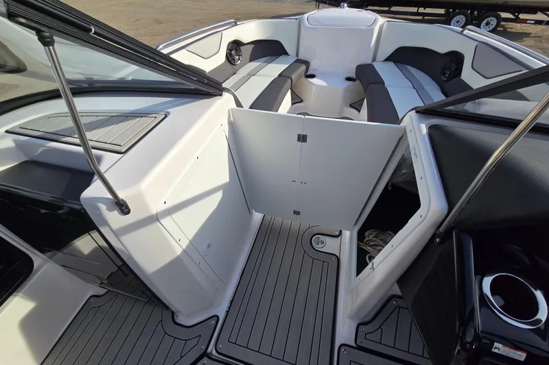 Slide: The Image of 2022 Yamaha Boats 212S interior with open storage, seating, and sleek design. - 37
