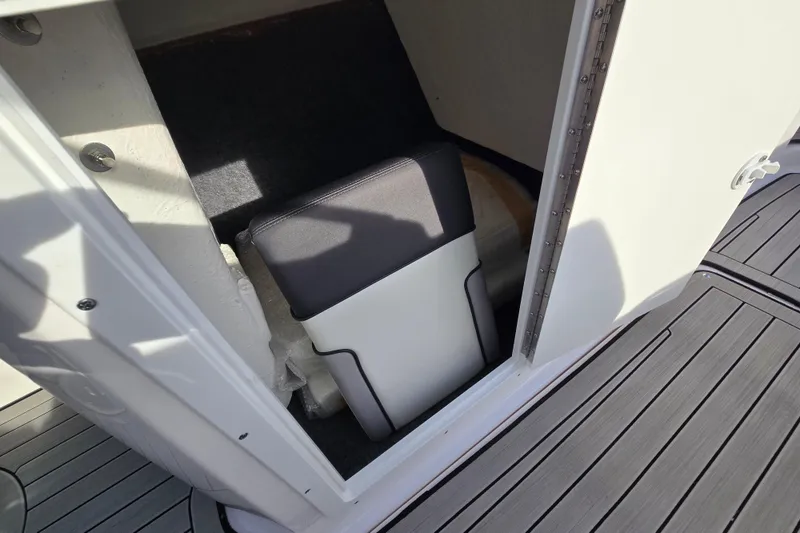 Slide: The Image of 2022 Yamaha Boats 212S interior storage compartment with cushioned seat. - 38