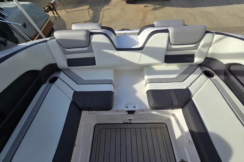 Slide: The Image of 2022 Yamaha Boats 212S interior seating with gray and white upholstery. - 39