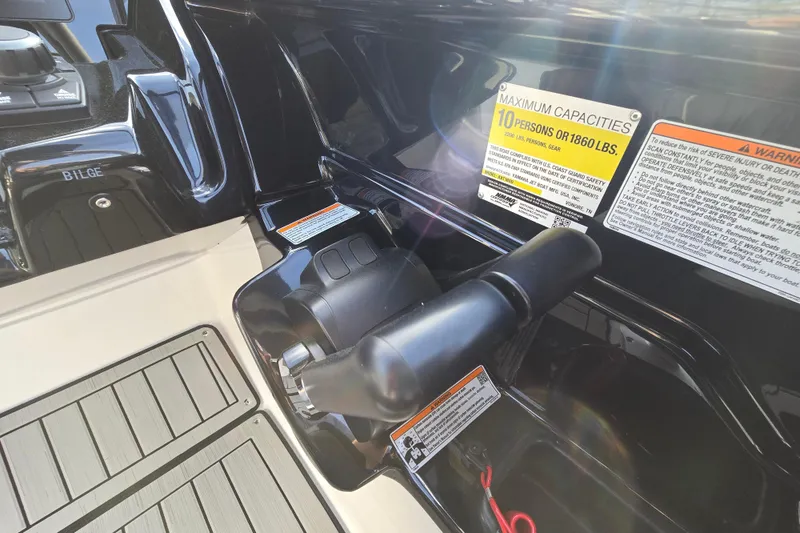 Slide: The Image of 2022 Yamaha Boats 212S control panel with capacity warning labels. - 46