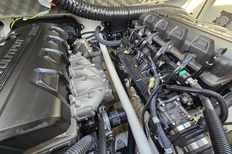 Slide: The Image of Engine compartment of a 2022 Yamaha Boats 212S, showcasing detailed components and wiring. - 53