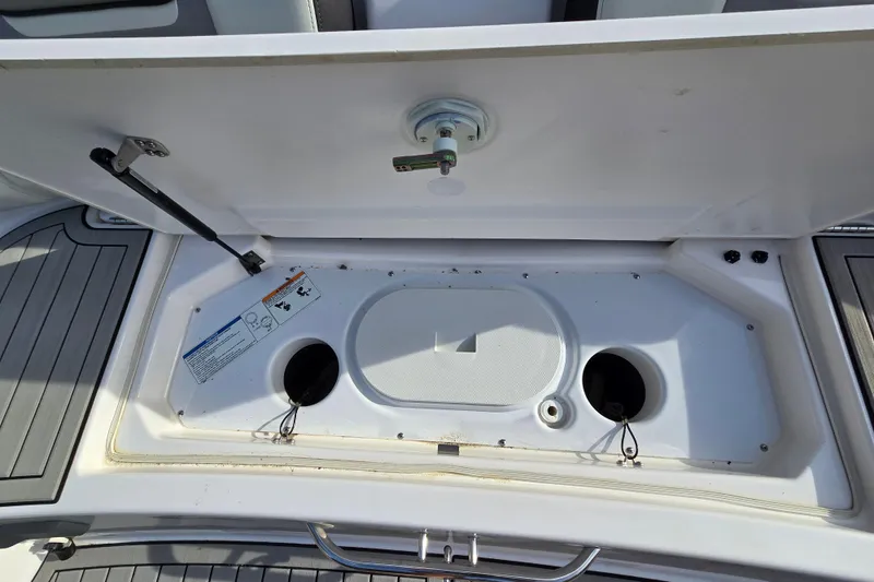 Slide: The Image of Open storage compartment on 2022 Yamaha Boats 212S, showcasing interior details and fittings. - 54