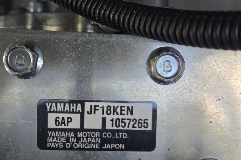 Slide: The Image of Close-up of Yamaha 212S 2022 engine label with serial number and bolts. - 55