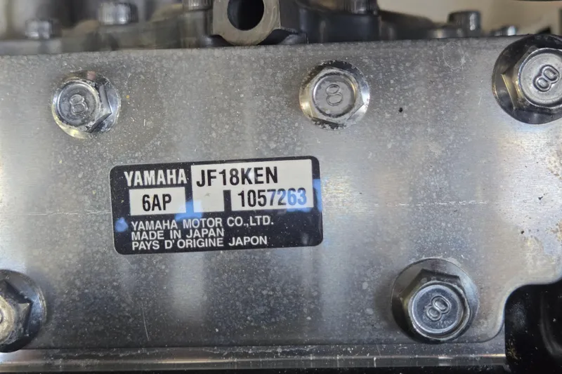 Slide: The Image of Close-up of Yamaha 212S engine label, showing model and serial number details. - 56