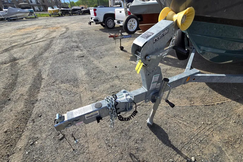 Slide: The Image of Trailer hitch of a 2022 Yamaha Boats 212S in a parking lot. - 57