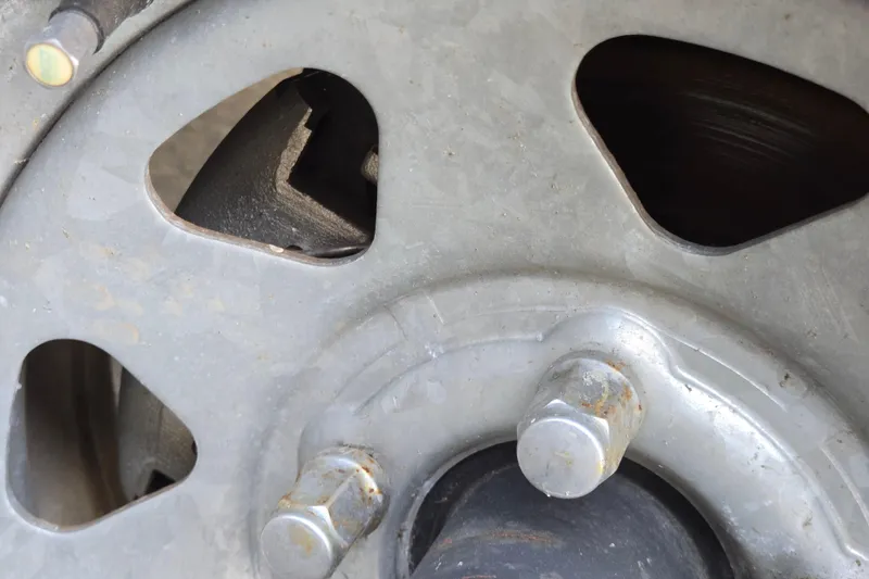 Slide: The Image of Close-up of a 2022 Yamaha Boats 212S wheel hub and lug nuts. - 58