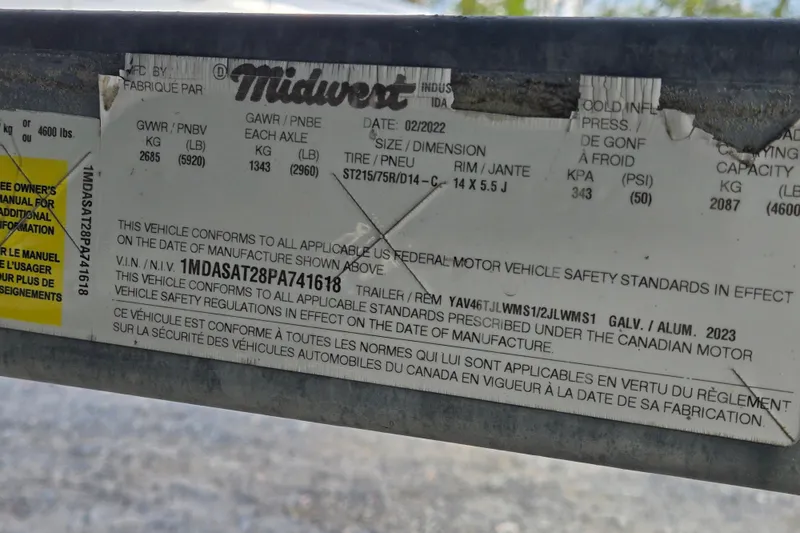 Slide: The Image of Label on a 2022 Yamaha Boats 212S trailer, detailing safety standards and specifications. - 59