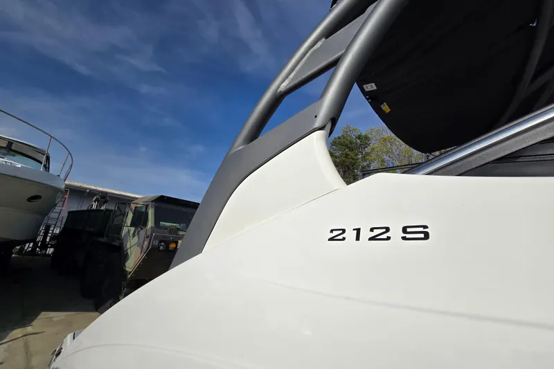 Slide: The Image of 2022 Yamaha Boats 212S in a marina setting under a clear blue sky. - 7