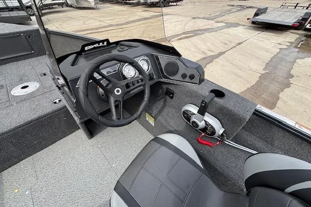 Slide: The Image of 2024 Lund 1650 Rebel XL Sport boat interior with steering wheel and control panel. - 11