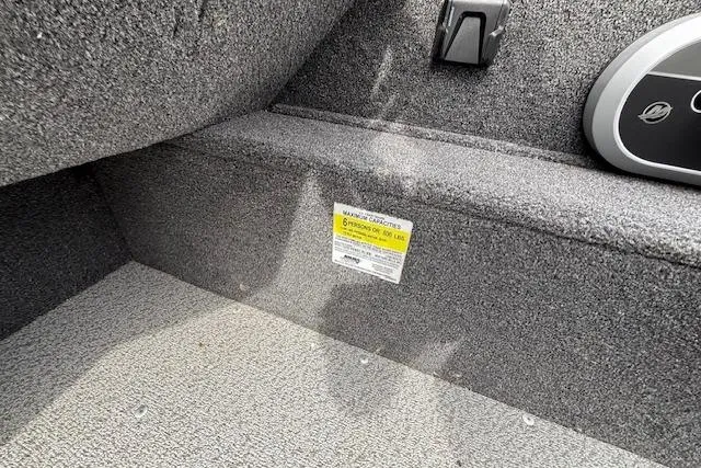Slide: The Image of Interior of 2024 Lund 1650 Rebel XL Sport boat showing seating and capacity label. - 12