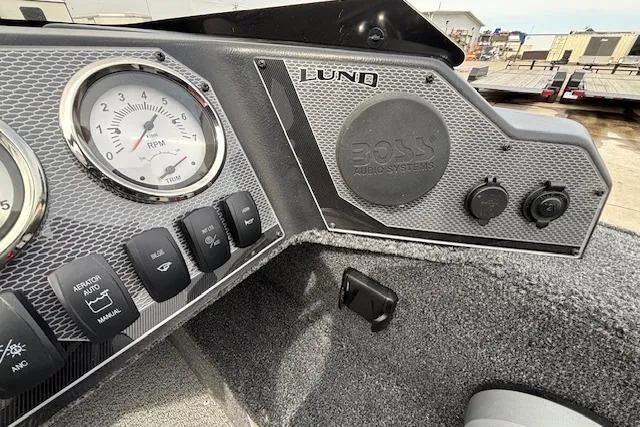 Slide: The Image of 2024 Lund 1650 Rebel XL Sport dashboard with gauges and Boss audio system. - 13