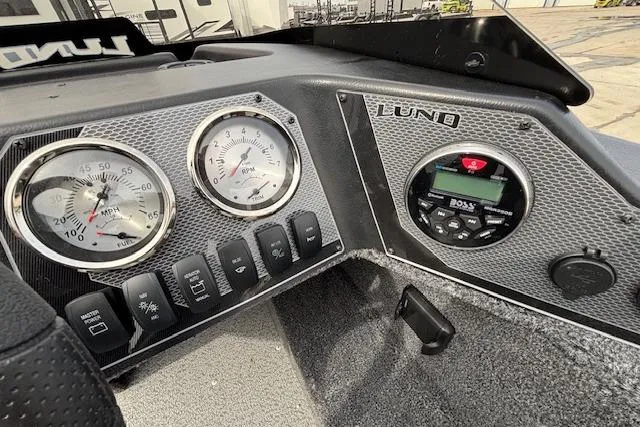 Slide: The Image of Dashboard of 2024 Lund 1650 Rebel XL Sport boat with gauges and controls. - 14