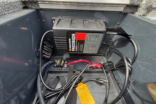 Slide: The Image of 2024 Lund 1650 Rebel XL Sport boat battery compartment with Minn Kota Precision charger. - 19