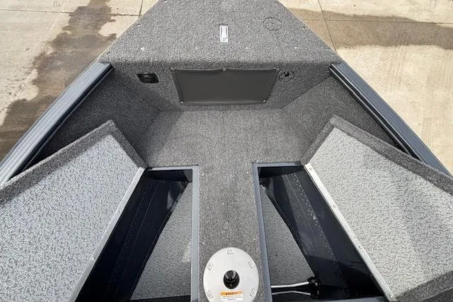 Slide: The Image of 2024 Lund 1650 Rebel XL Sport boat interior with carpeted storage compartments. - 20