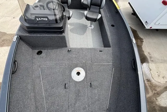 Slide: The Image of 2024 Lund 1650 Rebel XL Sport boat interior with seating and steering console. - 21