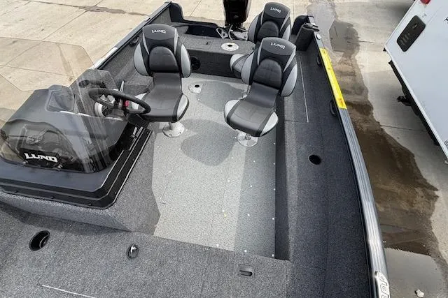 Slide: The Image of 2024 Lund 1650 Rebel XL Sport boat interior with seating and steering console. - 22