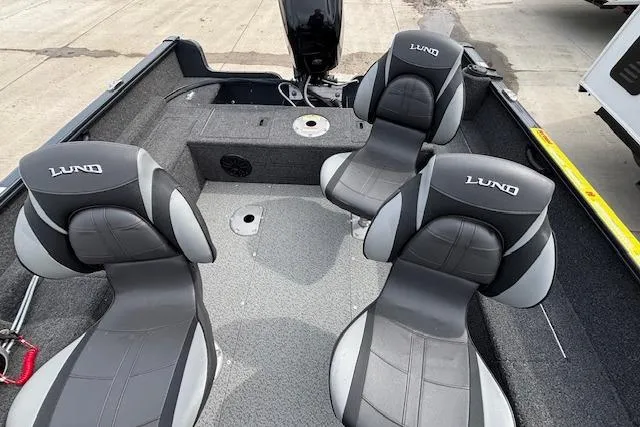 Slide: The Image of 2024 Lund 1650 Rebel XL Sport boat interior with three cushioned seats. - 23
