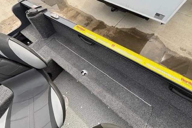 Slide: The Image of 2024 Lund 1650 Rebel XL Sport interior with gray seating and carpeted flooring. - 24