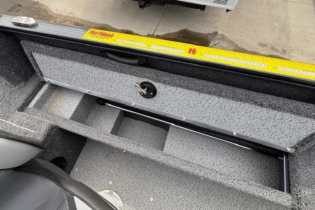 Slide: The Image of 2024 Lund 1650 Rebel XL Sport boat interior storage compartment with textured finish. - 25