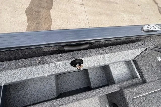 Slide: The Image of 2024 Lund 1650 Rebel XL Sport boat interior storage compartment with textured finish. - 27