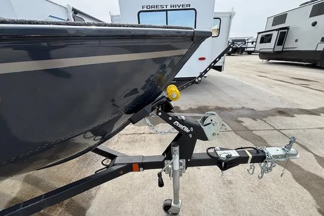 Slide: The Image of 2024 Lund 1650 Rebel XL Sport boat on trailer, parked near RVs. - 3